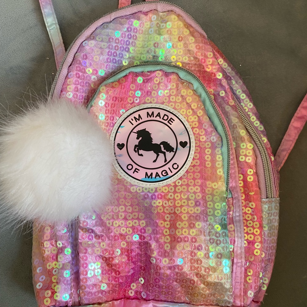Justice mini backpack/purse w/Pom Pom. Clear sequins over ombré rainbow colors.